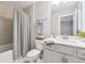 A well-lit bathroom with neutral tiling and a tub/shower combo at 802 Oak Promenade Ln, Canton, GA 30115