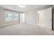 Light-filled bedroom with two bright windows and doors leading to hallway and closet space at 802 Oak Promenade Ln, Canton, GA 30115