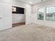 View of spacious bedroom with attached flex space, neutral walls, plush carpeting, and natural light from double-hung windows at 802 Oak Promenade Ln, Canton, GA 30115
