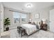 Minimalist bedroom featuring a bed, bedside tables, and natural light at 802 Oak Promenade Ln, Canton, GA 30115