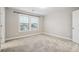 Cozy bedroom featuring plush carpet, natural light, and a front-facing window at 802 Oak Promenade Ln, Canton, GA 30115