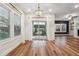 Bright dining area with hardwood floors, elegant chandelier, and sliding doors to backyard at 802 Oak Promenade Ln, Canton, GA 30115