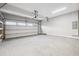 Spacious garage with natural light from windows in the garage door and lots of room for vehicles and storage at 802 Oak Promenade Ln, Canton, GA 30115