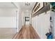 Charming hallway featuring wood-look floors, modern wainscoting, and stylish accents, creating an inviting entrance at 802 Oak Promenade Ln, Canton, GA 30115