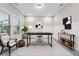 Well-lit office space with a modern desk, chair, and shelving unit at 802 Oak Promenade Ln, Canton, GA 30115