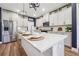 Kitchen with island, stainless steel appliances, white cabinets and subway tile backsplash at 802 Oak Promenade Ln, Canton, GA 30115