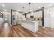 Beautiful kitchen with stainless steel appliances, island, hardwood floors, and pendant lighting at 802 Oak Promenade Ln, Canton, GA 30115