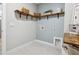 Well-organized laundry room with custom wooden shelving and sleek tile flooring at 802 Oak Promenade Ln, Canton, GA 30115