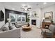 Cozy living room featuring a fireplace, ceiling fan, and comfortable seating at 802 Oak Promenade Ln, Canton, GA 30115