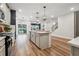 Open-concept kitchen and living room area, featuring hardwood floors and plenty of natural light at 802 Oak Promenade Ln, Canton, GA 30115