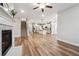 Open-concept space with hardwood floors, kitchen and fireplace featuring a ceiling fan at 802 Oak Promenade Ln, Canton, GA 30115