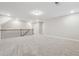 Bright, open loft area with neutral paint, carpet, and a view of the staircase at 802 Oak Promenade Ln, Canton, GA 30115