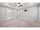 Expansive main bedroom with tray ceiling, plush carpeting, and doorway to an ensuite bathroom, offering comfort at 802 Oak Promenade Ln, Canton, GA 30115