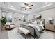 Serene primary bedroom with tray ceiling, neutral tones, and comfortable furnishings at 802 Oak Promenade Ln, Canton, GA 30115