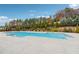 Community pool surrounded by lush landscaping and a secure fence, offering a serene and safe recreational space at 802 Oak Promenade Ln, Canton, GA 30115