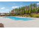 Community pool surrounded by lush landscaping and a secure fence, offering a serene and safe recreational space at 802 Oak Promenade Ln, Canton, GA 30115