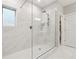 Glass enclosed shower featuring white tile with gray veining, large rain head and built in seat at 802 Oak Promenade Ln, Canton, GA 30115