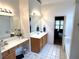 Large bathroom with double sinks, garden tub, and access to bedroom at 3559 Gus Way, Powder Springs, GA 30127