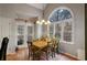 Bright eat-in kitchen area with wood table and access to backyard at 3559 Gus Way, Powder Springs, GA 30127