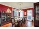 Formal dining room with dark wood table and red walls at 3559 Gus Way, Powder Springs, GA 30127