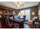 Home office features built-in bookcases and hardwood floors at 3559 Gus Way, Powder Springs, GA 30127