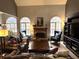 Bright living room with hardwood floors, stone fireplace and three windows at 3559 Gus Way, Powder Springs, GA 30127