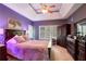 Main bedroom with dark wood furniture and purple walls at 3559 Gus Way, Powder Springs, GA 30127