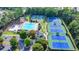 An aerial view displays community amenities, including a pool, playground, and tennis courts, surrounded by lush greenery at 1400 Lamont Cir, Dacula, GA 30019