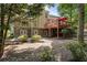 Home exterior with a deck, patio, stone landscaping, and greenery in a private backyard setting at 1400 Lamont Cir, Dacula, GA 30019