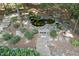 A serene backyard pond area with lush greenery and stone features offers a relaxing outdoor retreat at 1400 Lamont Cir, Dacula, GA 30019
