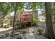 Home exterior with a deck, patio, stone landscaping, and greenery in a private backyard setting at 1400 Lamont Cir, Dacula, GA 30019