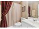 Cozy bathroom with striped walls, a vanity, and a shower-tub combo, designed for compact convenience at 1400 Lamont Cir, Dacula, GA 30019