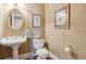 A charming powder room with a pedestal sink, elegant fixtures, and decorative accents at 1400 Lamont Cir, Dacula, GA 30019