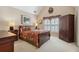 Cozy bedroom with floral bedding, plantation shutters, and ample storage, providing comfort and functionality at 1400 Lamont Cir, Dacula, GA 30019
