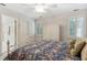 Comfortable bedroom featuring neutral walls, ceiling fan, and plantation shutters for natural light at 1400 Lamont Cir, Dacula, GA 30019
