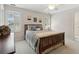 Comfortable bedroom with a wooden bed frame, ceiling fan, and plantation shutters at 1400 Lamont Cir, Dacula, GA 30019