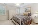 Cozy bedroom featuring a floral bedspread, white closet, and plantation shutters at 1400 Lamont Cir, Dacula, GA 30019