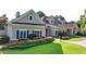 Well-maintained clubhouse exterior with manicured lawn and colorful flower beds, offering a welcoming curb appeal at 1400 Lamont Cir, Dacula, GA 30019