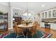 Dining area features hardwood floors, a wooden table with chairs, and a view to the living room at 1400 Lamont Cir, Dacula, GA 30019
