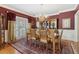 Elegant dining room with classic decor, a chandelier, and windows providing natural light at 1400 Lamont Cir, Dacula, GA 30019