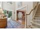Warm foyer featuring hardwood floors, a staircase, and view into the dining room, creating an inviting entrance at 1400 Lamont Cir, Dacula, GA 30019