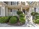 Inviting front porch with manicured hedges, white railings and steps, offering a warm welcome to the home at 1400 Lamont Cir, Dacula, GA 30019