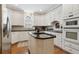 Kitchen with an island, white cabinets, stone countertops and stainless appliances at 1400 Lamont Cir, Dacula, GA 30019