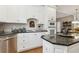 Kitchen with granite countertops, white cabinets, tile backsplash, and stainless steel appliances at 1400 Lamont Cir, Dacula, GA 30019