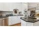 A well-appointed kitchen with white cabinets, granite countertops, and stainless steel appliances at 1400 Lamont Cir, Dacula, GA 30019