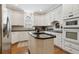 Kitchen featuring an island with dark granite countertops, white cabinets, and stainless appliances at 1400 Lamont Cir, Dacula, GA 30019