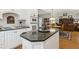 Modern kitchen island featuring granite countertops, white cabinets, and stainless steel appliances at 1400 Lamont Cir, Dacula, GA 30019