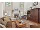 Comfortable living room featuring a cozy fireplace, hardwood floors, and custom built-ins at 1400 Lamont Cir, Dacula, GA 30019