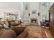 Spacious living room with high ceilings, fireplace, large windows, and comfortable seating for relaxation and gatherings at 1400 Lamont Cir, Dacula, GA 30019