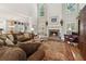 Spacious living room with high ceilings, a stone fireplace, and abundant natural light at 1400 Lamont Cir, Dacula, GA 30019